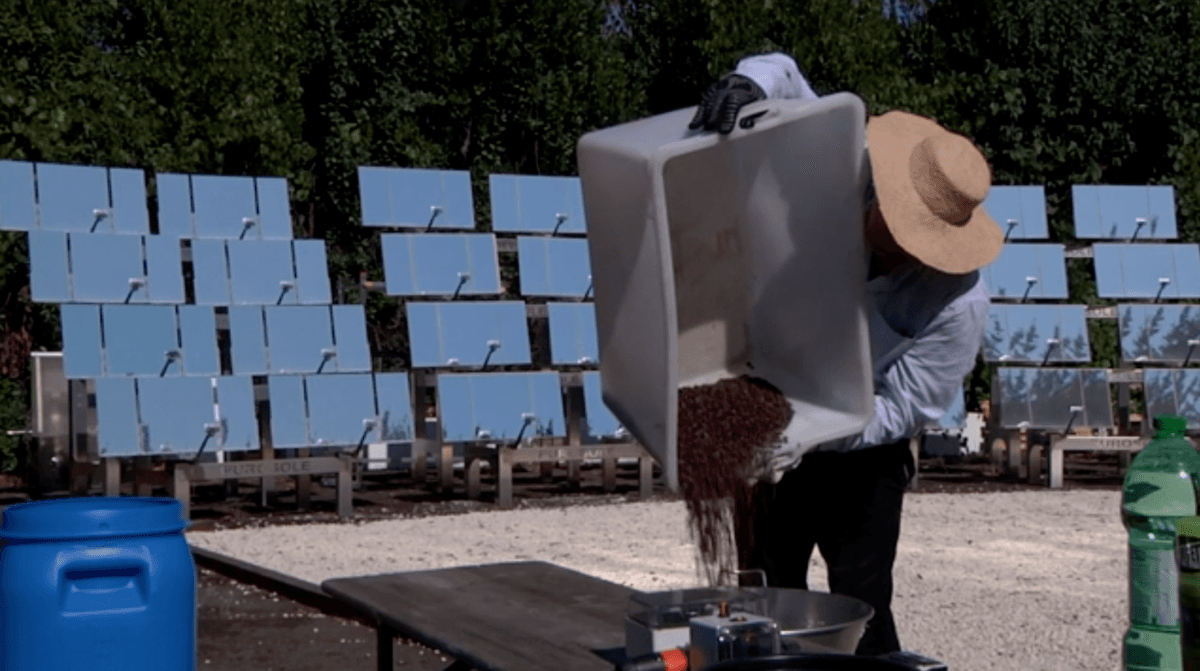 Antonio Durbè pours coffee beans at a PuroSole coffee roasting solar plant in Rome in a still from video taken on Oct. 13, 2021. (AP/Screenshot via The Epoch Times)