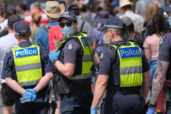 Police observe Australians protesting against government-mandated health restrictions, increasing powers, and the Pandemic Bill in Melbourne, Australia, on Nov. 6, 2021. (Supplied)