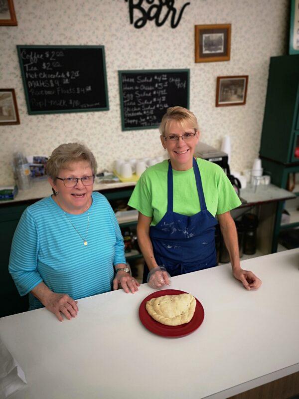 Bette Prebonich (L) and her daughter Laura Collins show off a beef and vegetable pasty at Pep’s Bake Shop in Virginia, Minn. (Emma Buls)
