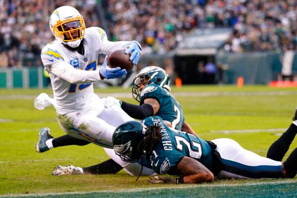 Los Angeles Chargers wide receiver Keenan Allen (13) is brought down with the ball by Philadelphia Eagles defensive back Andre Chachere (21) and Philadelphia Eagles cornerback Darius Slay (2) during the first half of an NFL football game in Philadelphia, on Nov. 7, 2021. (Matt Rourke/AP Photo)