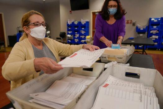 A file photo shows election workers processing ballots (AP Photo/Seth Wenig)