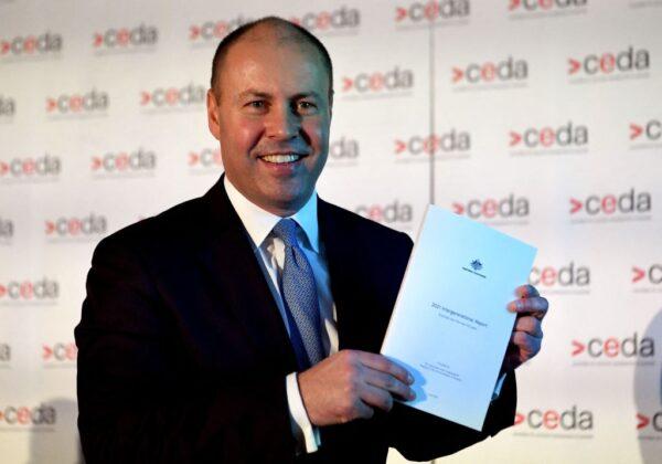 Australian Treasurer Josh Frydenberg holds a copy of the 2021 Intergenerational Report in Melbourne, Australia, on June 28, 2021. (William West/AFP via Getty Images)