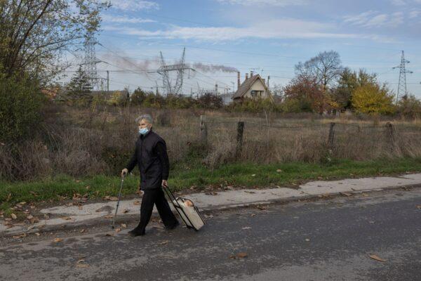A woman walks along a street near the Chinese-owned HBIS Serbia steel mill, in the village of Ralja, near the city of Smederevo, Serbia, on Nov. 3, 2021. (Marko Djurica/Reuters)