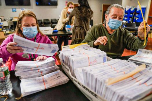 Election workers Bernadette Witt, left, and JoAnn Bartlett, right, process and double-check mail-in ballots for Bergen County in Hackensack, N.J., on Nov. 3, 2021. (Seth Wenig/AP Photo)