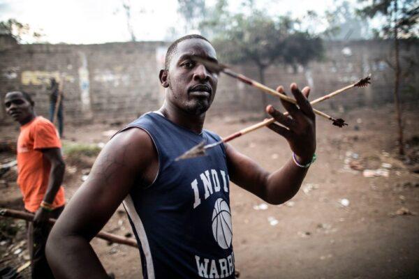 A man brandishes arrows during a street battle between Luo supporters of defeated opposition leader Raila Odinga and members of President Uhuru Kenyatta’s Kikuyu ethnic group, both living in the Mathare slum, Nairobi, on Aug. 13, 2017. (Marco Longari/AFP via Getty Images)