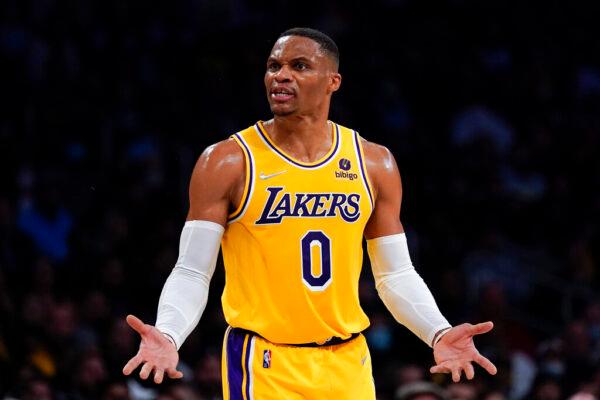 Los Angeles Lakers guard Russell Westbrook (0) disputes a call, causing a delay of game penalty during the second half of an NBA basketball game against the Charlotte Hornets in Los Angeles, on Nov. 8, 2021. (Ashley Landis/AP Photo)