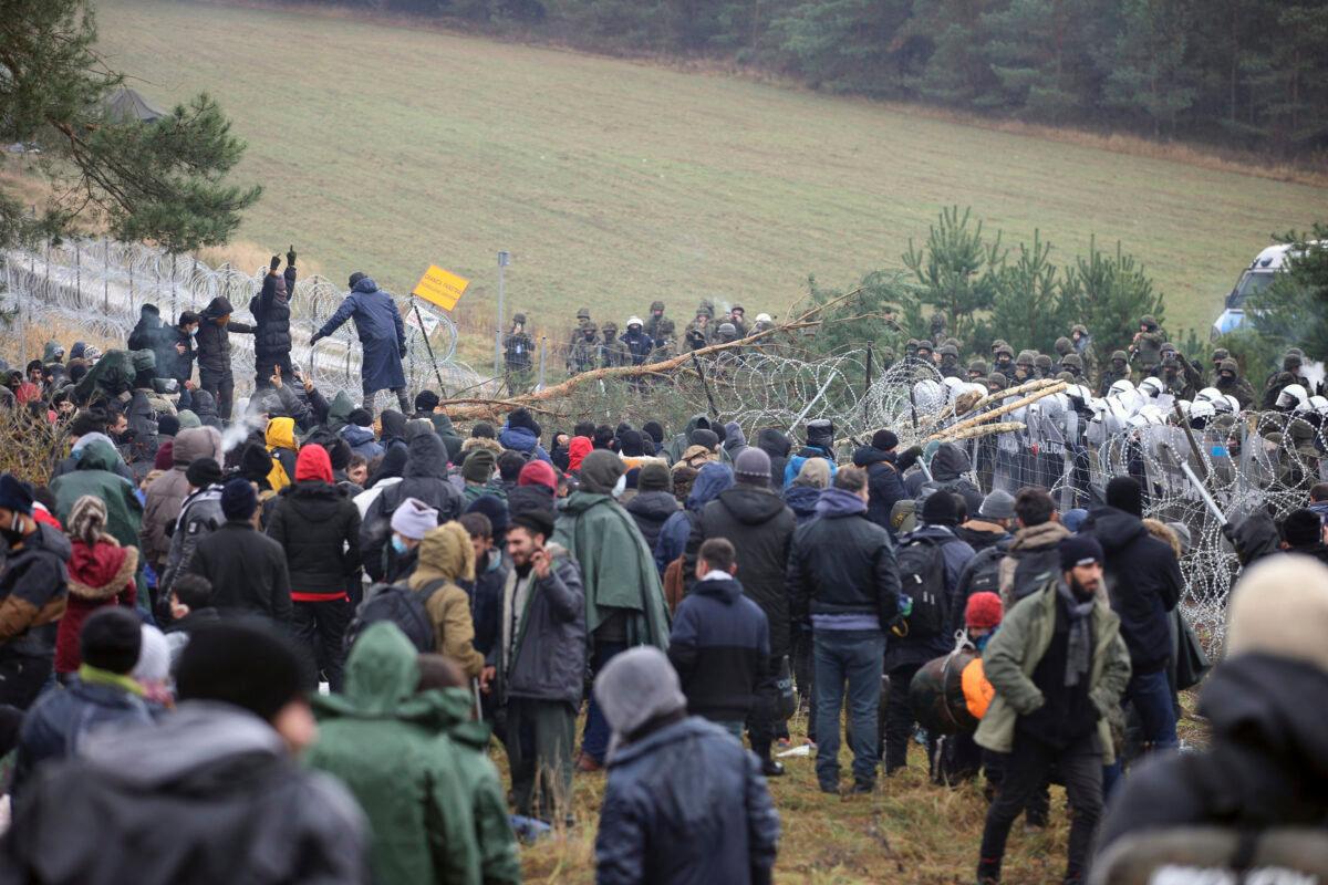 Migrants from the Middle East and elsewhere gather at the Belarus-Poland border near Grodno, Belarus, Monday, Nov. 8, 2021. (Leonid Shcheglov/BelTA via AP)