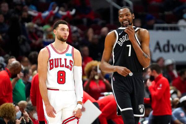 Brooklyn Nets' Kevin Durant (7) walks away from Chicago Bulls' Zach LaVine smiling after the pair spoke to each other during a break in the action in the first half of an NBA basketball game in Chicago, on Nov. 8, 2021. (Charles Rex Arbogast/AP Photo)