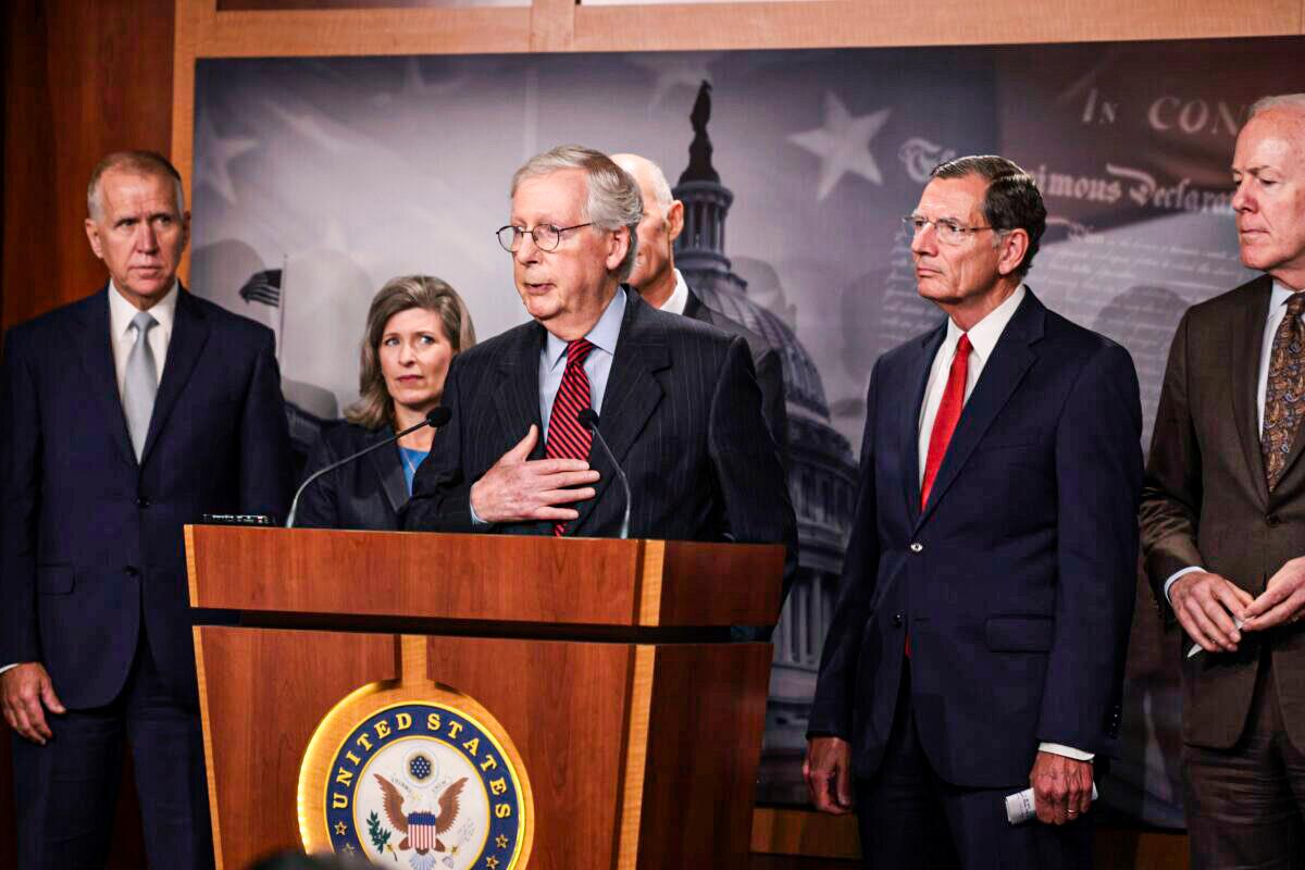 Senate Minority Leader Mitch McConnell (R-Ky.) (center) speaks to reporters as other senators stand by, in Washington, on Sept. 22, 2021. (Anna Moneymaker/Getty Images)