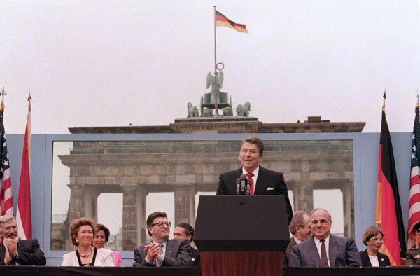 President Ronald Reagan, commemorating the 750th anniversary of Berlin, addresses the people of West Berlin at the base of the Brandenburg Gate, near the Berlin Wall, on June 12, 1987. Due to the amplification system being used, the President's words could also be heard on the Eastern (communist-controlled) side of the wall. (MIKE SARGENT/AFP via Getty Images)