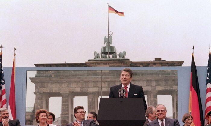 President Ronald Reagan, commemorating the 750th anniversary of Berlin, addresses the people of West Berlin at the base of the Brandenburg Gate, near the Berlin Wall, on June 12, 1987. Due to the amplification system being used, the President's words could also be heard on the Eastern (communist-controlled) side of the wall. (Mike Sargent/AFP via Getty Images)