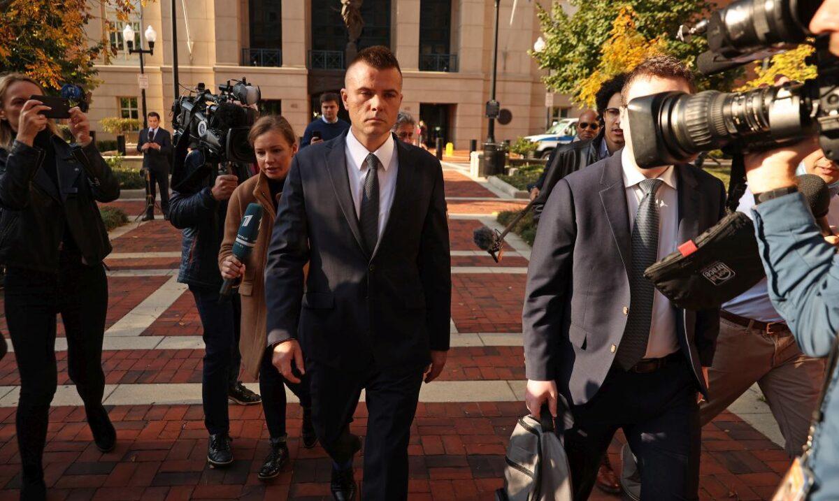 Russian analyst Igor Danchenko is pursued by journalists as he departs the Albert V. Bryan U.S. Courthouse after being arraigned in Alexandria, Va., on Nov. 10, 2021. (Chip Somodevilla/Getty Images)