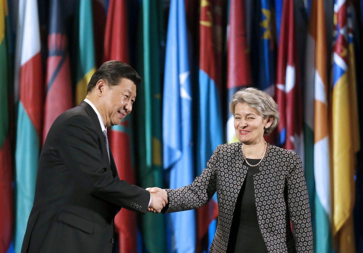 Chinese leader Xi Jinping shakes hands with then-UNESCO Director-General Irina Bokova after delivering a speech at UNESCO headquarters in Paris on March 27, 2014. (Christian Hartmann/AFP via Getty Images)