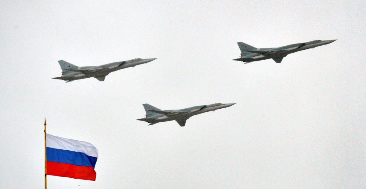 Russian Tupolev Tu-22M supersonic strategic bombers fly above the Kremlin in Moscow, on May 7, 2014. (Yuri Kadobnov/AFP via Getty Images)