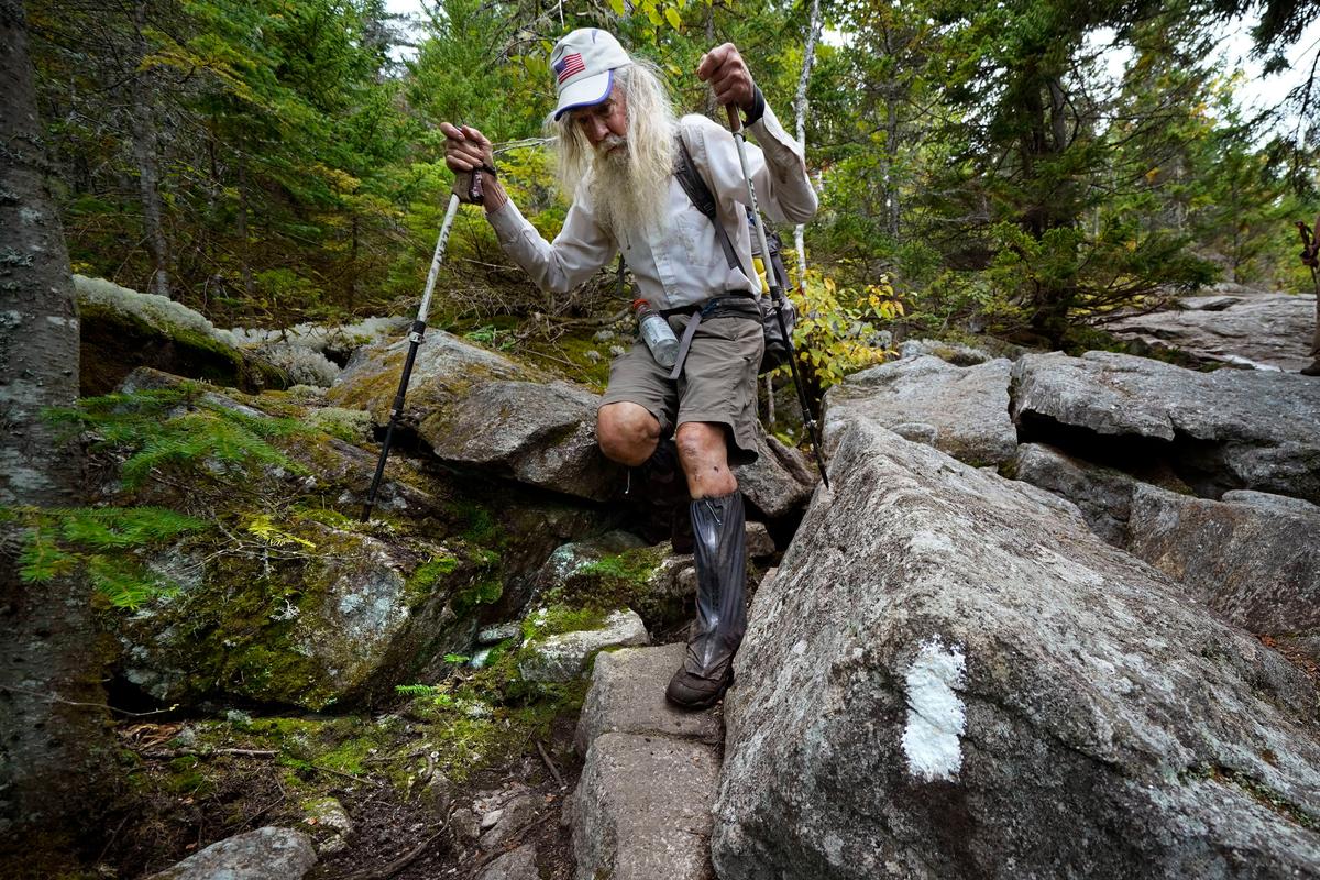 M.J. Eberhart, 83, carefully makes his way through large rocks while descending Mount Hayes on the Appalachian Trail. (Robert F. Bukaty/AP Photo).