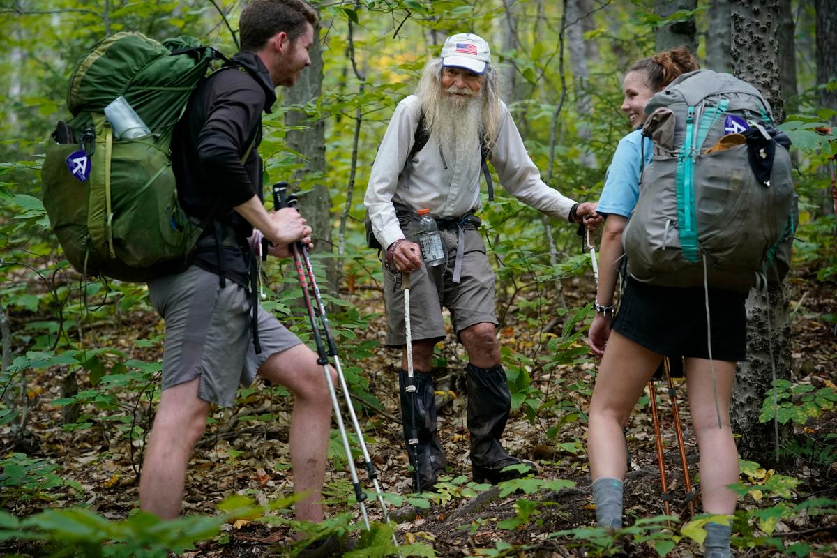 83-year-old M.J. Eberhart (C) shares trail information with a pair of thru-hikers. (Robert F. Bukaty/AP Photo)