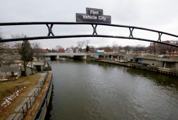 A sign over the Flint River in Flint, Mich., on Jan. 26, 2016. (AP Photo/Carlos Osorio, File)