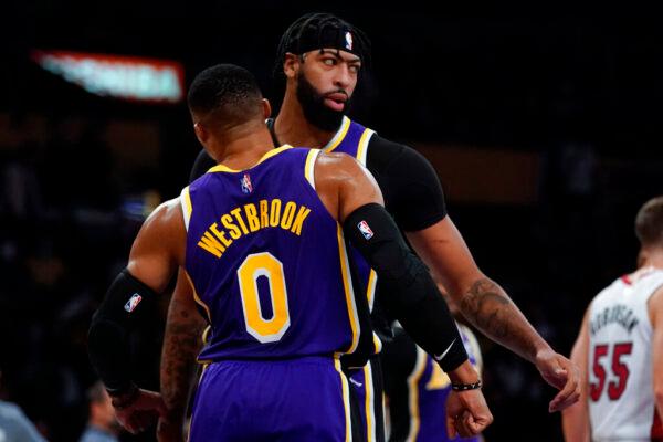 Los Angeles Lakers guard Russell Westbrook (0) and forward Anthony Davis (3) celebrate after scoring during the first half of an NBA basketball game against the Miami Heat in Los Angeles, on Nov. 10, 2021. (Ashley Landis/AP Photo)