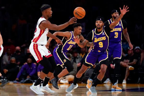 Miami Heat forward Jimmy Butler (22) passes the ball against Los Angeles Lakers forward Kent Bazemore (9) during the first half of an NBA basketball game in Los Angeles, on Nov. 10, 2021. (Ashley Landis/AP Photo)
