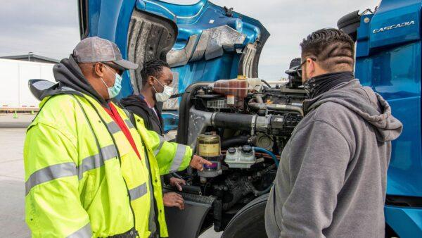 A Roadmaster Drivers School instructor explains the working components of a long-haul truck at the school's campus in Phoenix. (Roadmaster Drivers School photo)