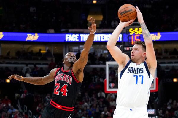 Dallas Mavericks guard Luka Doncic shoots against Chicago Bulls forward Javonte Green during the first half of an NBA basketball game in Chicago, Wednesday, Nov. 10, 2021. (AP Photo/Nam Y. Huh)