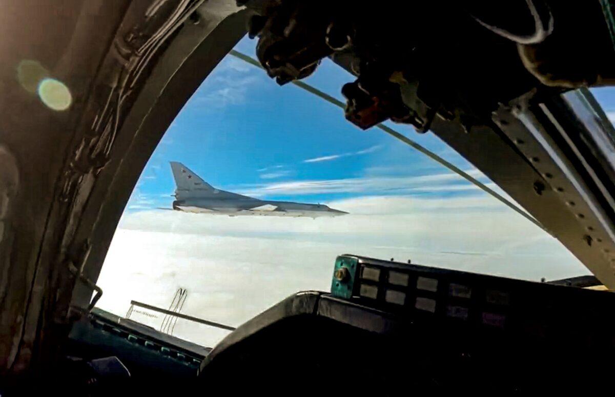 In this handout photo taken from video released by Russian Defense Ministry Press Service on Wednesday, Nov. 10, 2021, a long-range Tu-22M3 bomber of the Russian Aerospace Forces flies to patrol in the airspace of Belarus, Thursday, Nov. 11, 2021. (Russian Defense Ministry Press Service via AP)