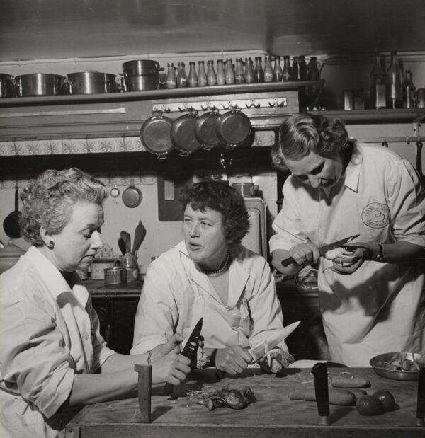 The authors of “Mastering the Art of Fine Cooking”: (L–R) Louisette Bertholle, Julia Child, and Simone Beck peel vegetables at École Des Trois Gourmandes, a cooking school in Paris. (Photograph by Paul Child; © Schlesinger Library, Radcliffe Institute, Harvard University. Courtesy of Sony Pictures Classics)