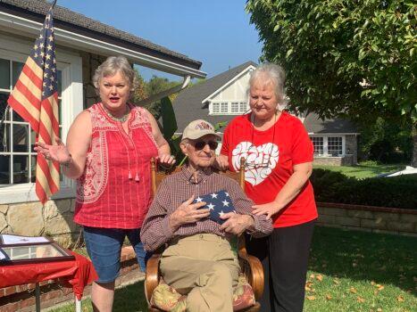 World War II veteran James Bradley and his two daughters at his 100th birthday celebration. (Linda Jiang/The Epoch Times)