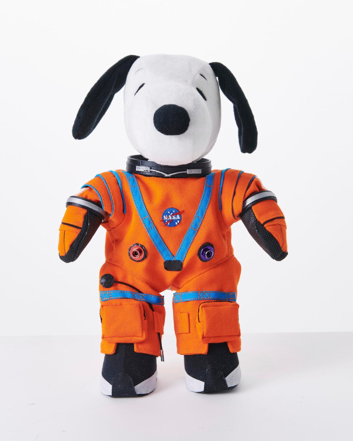 This product image shows a stuffed toy version of Snoopy wearing a NASA spacesuit. (Peanuts Worldwide via AP)