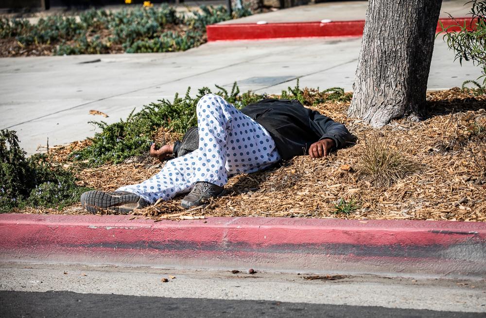 A homeless man sleeps in Venice, Calif., on Nov. 10, 2021. (John Fredricks/The Epoch Times)