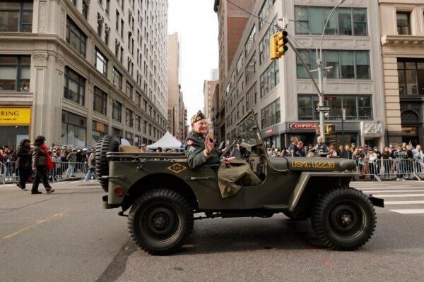A veteran of the U.S. Marine Corps waves at the crowd during the 2021 New York City Veterans Day Parade on Nov. 11, 2021. (Michael Loccisano/Getty Images)