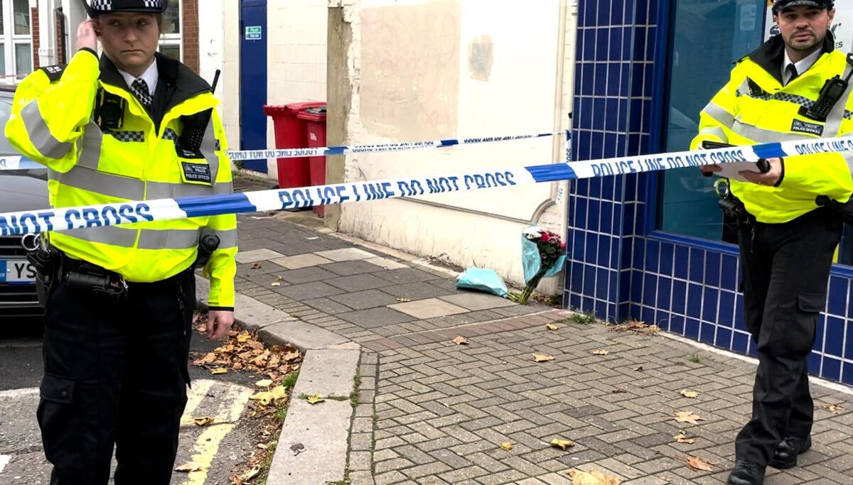 Screenshot taken from PA video of flowers at the scene of a stabbing incident in Albany Parade, Brentford, England, on Nov. 13, 2021. (Luke O'Reilly/PA)