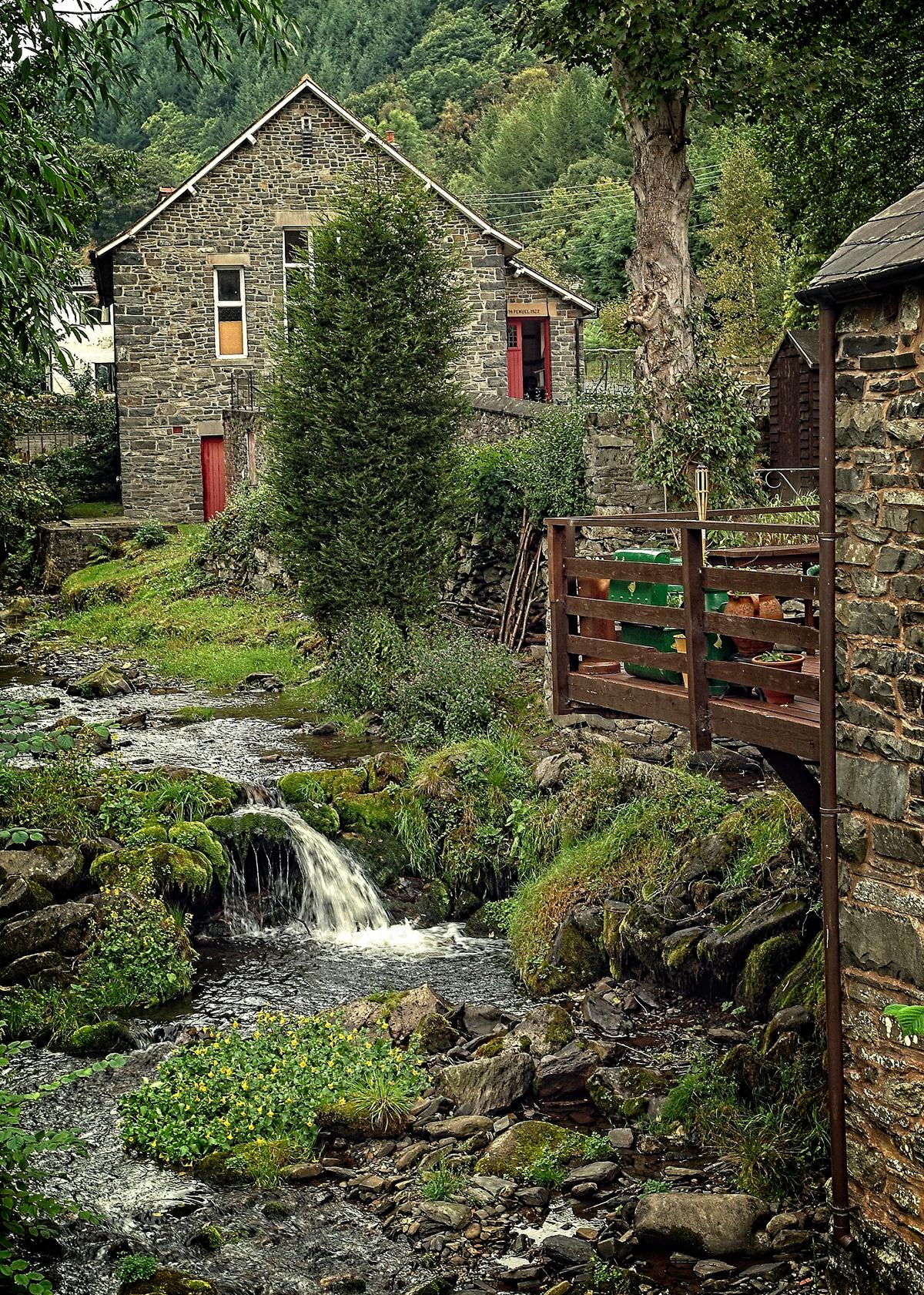 A stream running through a small village in the countryside of northern Wales. Hiking from village to village is a popular tourist activity in Wales. (Copyright Fred J. Eckert)