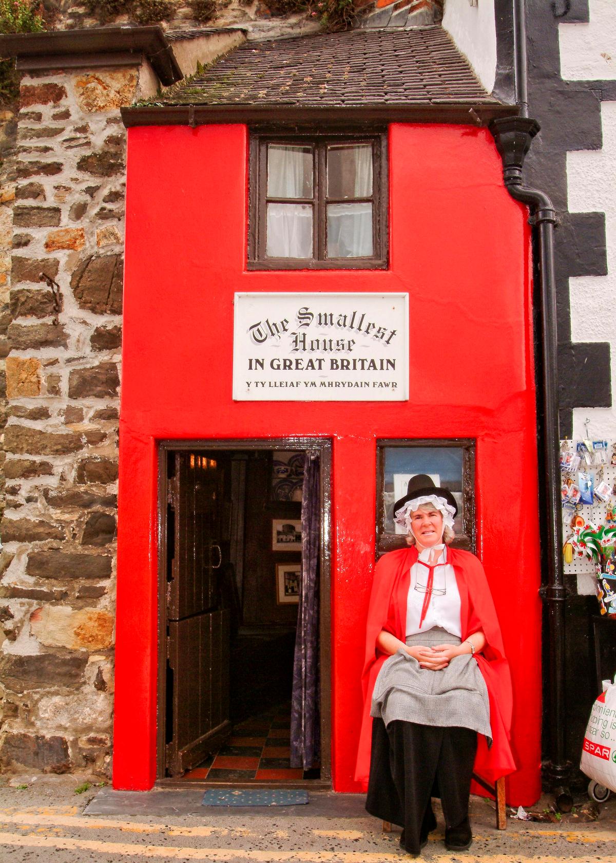 This woman dressed in a traditional Welsh outfit greets visitors to a house in Conwy that's billed as the smallest house in Great Britain. (Copyright Fred J. Eckert)