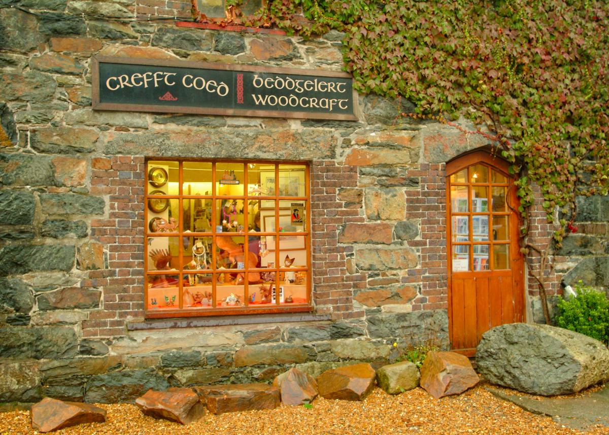 The abundance of slate and stone in Wales is put to good use in constructing sturdy and attractive structures such as this woodcraft shop in the town of Beddgelert. (Copyright Fred J. Eckert)
