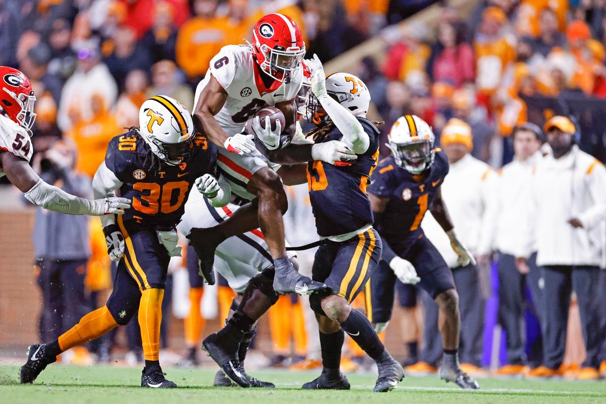 Georgia running back Kenny McIntosh (6) leaps as he's hit by Tennessee linebackers Roman Harrison (30) and Jeremy Banks (33) during the second half of an NCAA college football game in Knoxville, Tenn., on Nov. 13, 2021. (Wade Payne/AP Photo)