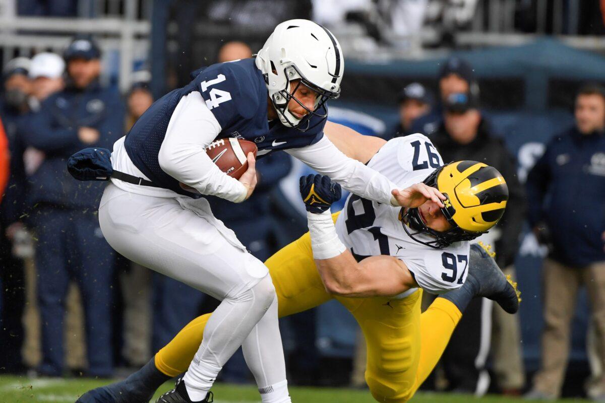 Michigan defensive end Aidan Hutchinson (97) tackles Penn State quarterback Sean Clifford (14) in the first quarter of an NCAA college football game in State College, Pa., Nov. 13, 2021. (Barry Reeger/AP Photo)