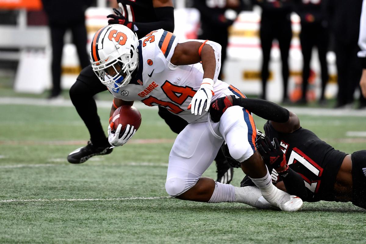 Syracuse running back Sean Tucker (34) is brought down by Louisville defensive back Kenderick Duncan (27) during the first half of an NCAA college football game in Louisville, Ky., on Nov. 13, 2021. (Timothy D. Easley/AP Photo)