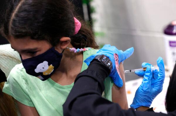 8-year-old Ava Onaissi receives a pediatric Pfizer COVID-19 vaccination during a vaccination clinic at Emmanuel Baptist Church in San Jose, Calif. on Nov. 3, 2021. (Justin Sullivan/Getty Images)