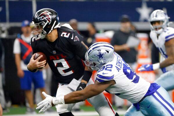 Atlanta Falcons quarterback Matt Ryan (2) is sacked by Dallas Cowboys defensive end Dorance Armstrong (92) in the first half of an NFL football game in Arlington, Tex., on Nov. 14, 2021. (Ron Jenkins/AP Photo)
