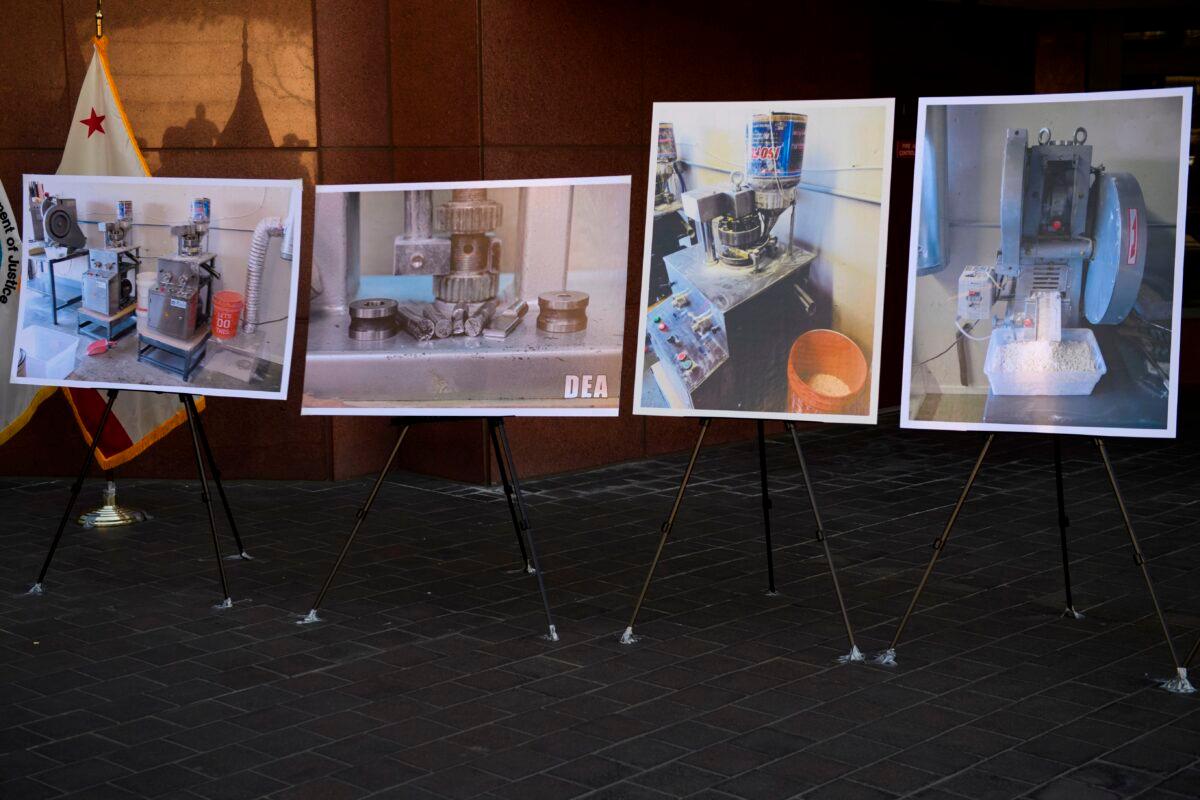 Photographs of fentanyl pills and pill press machines seized by authorities are displayed during a news conference outside the Roybal Federal Building in Los Angeles on Feb. 24, 2021. (Patrick T. Fallon//AFP via Getty Images)