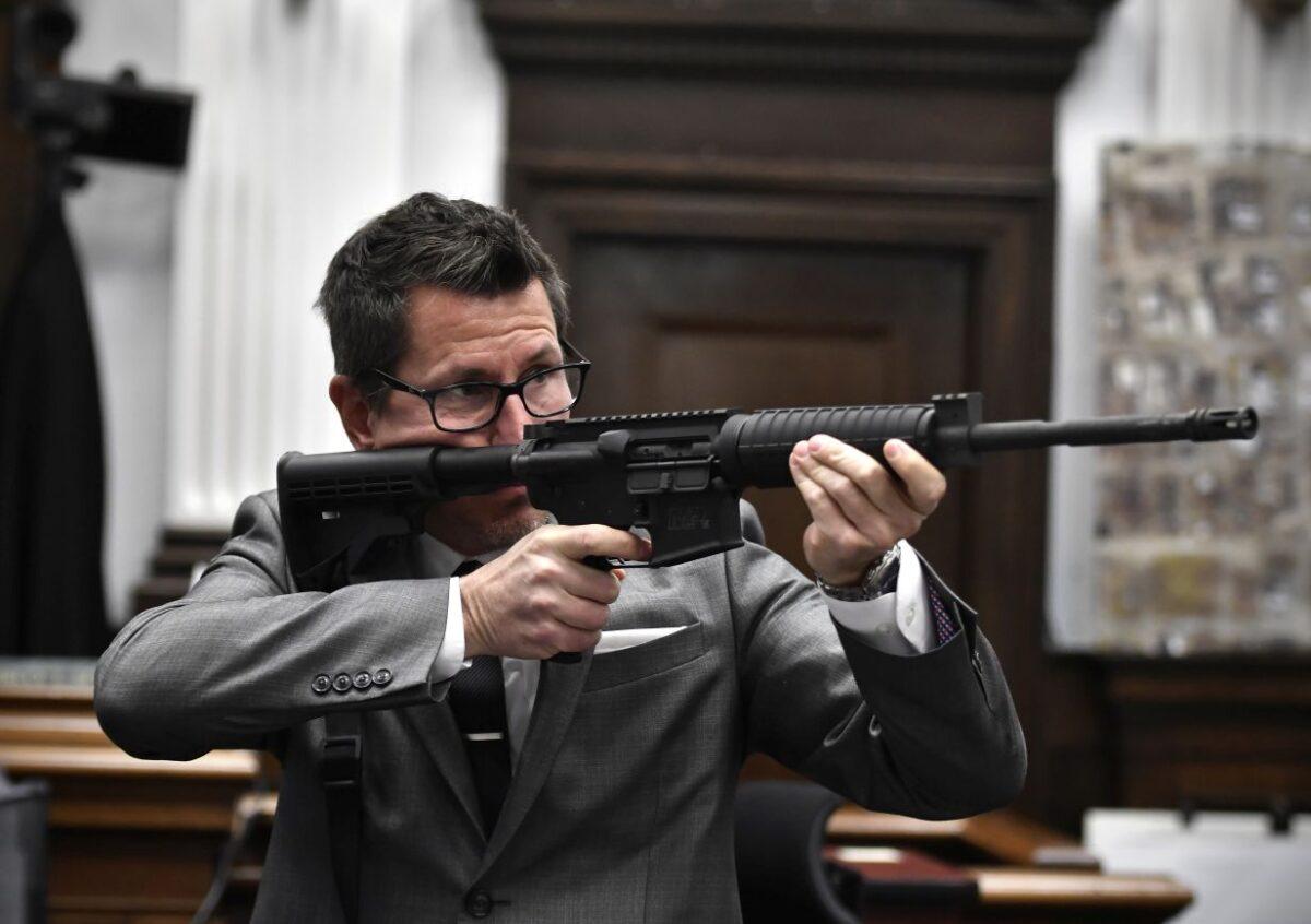 Assistant District Attorney Thomas Binger holds Kyle Rittenhouse's gun as he gives the state's closing argument in Kyle Rittenhouse's trial in Kenosha, Wis., on Nov. 15, 2021. ( Sean Krajacic/Pool/Getty Images)