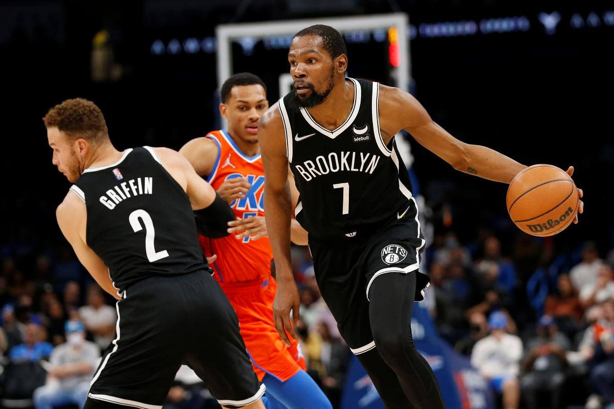 Brooklyn Nets forward Kevin Durant (7) drives the ball past Oklahoma City Thunder forward Darius Bazley (7) who is blocked by Nets forward Blake Griffin (2) during the first half of an NBA basketball game in Oklahoma City, on Nov. 14, 2021. (Garett Fisbeck/AP Photo)