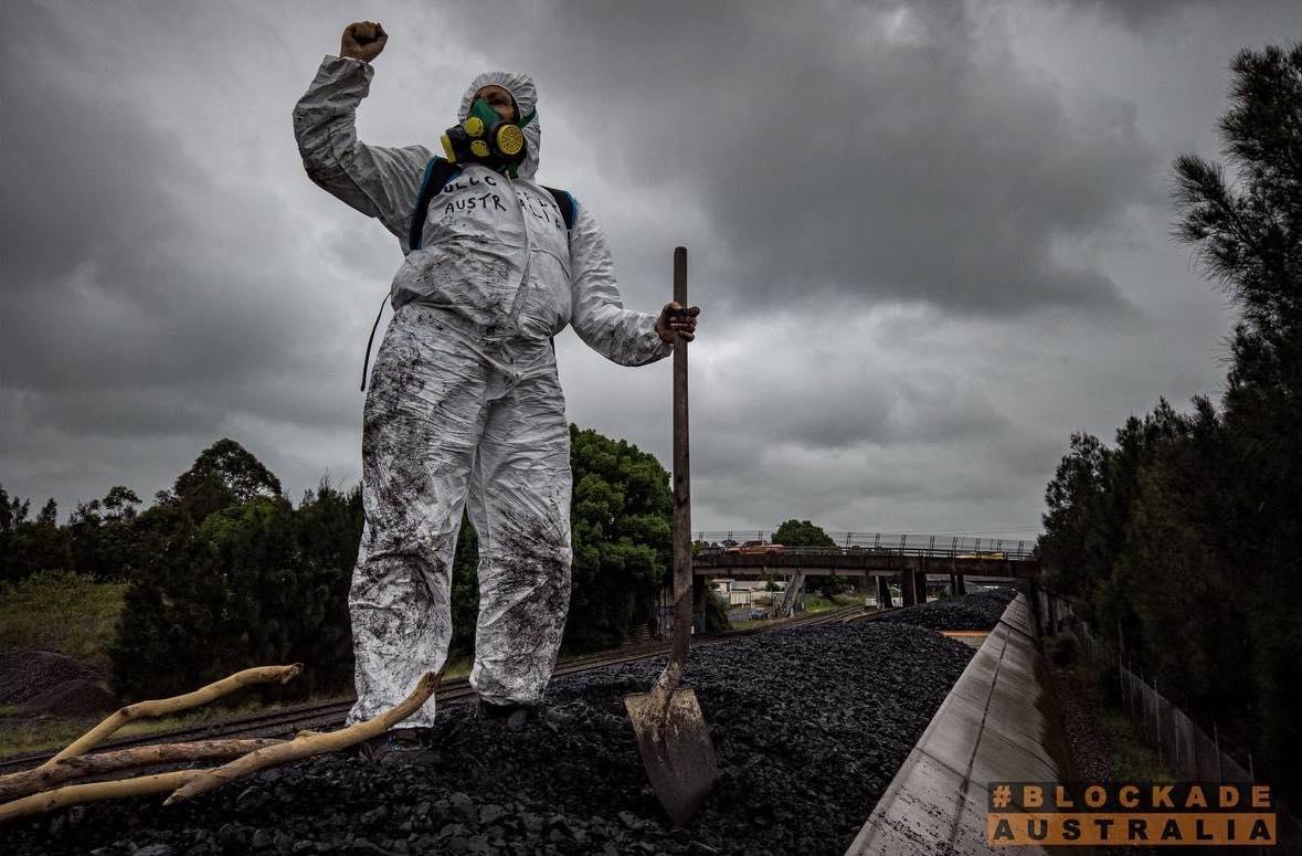 Hazmat-clad activist for Blockade Australia halts coal trains near the Port of Newcastle, Australia on Nov. 11, 2021. This is the eighth action to block the rail since Nov. 8. (Blockade Australia)