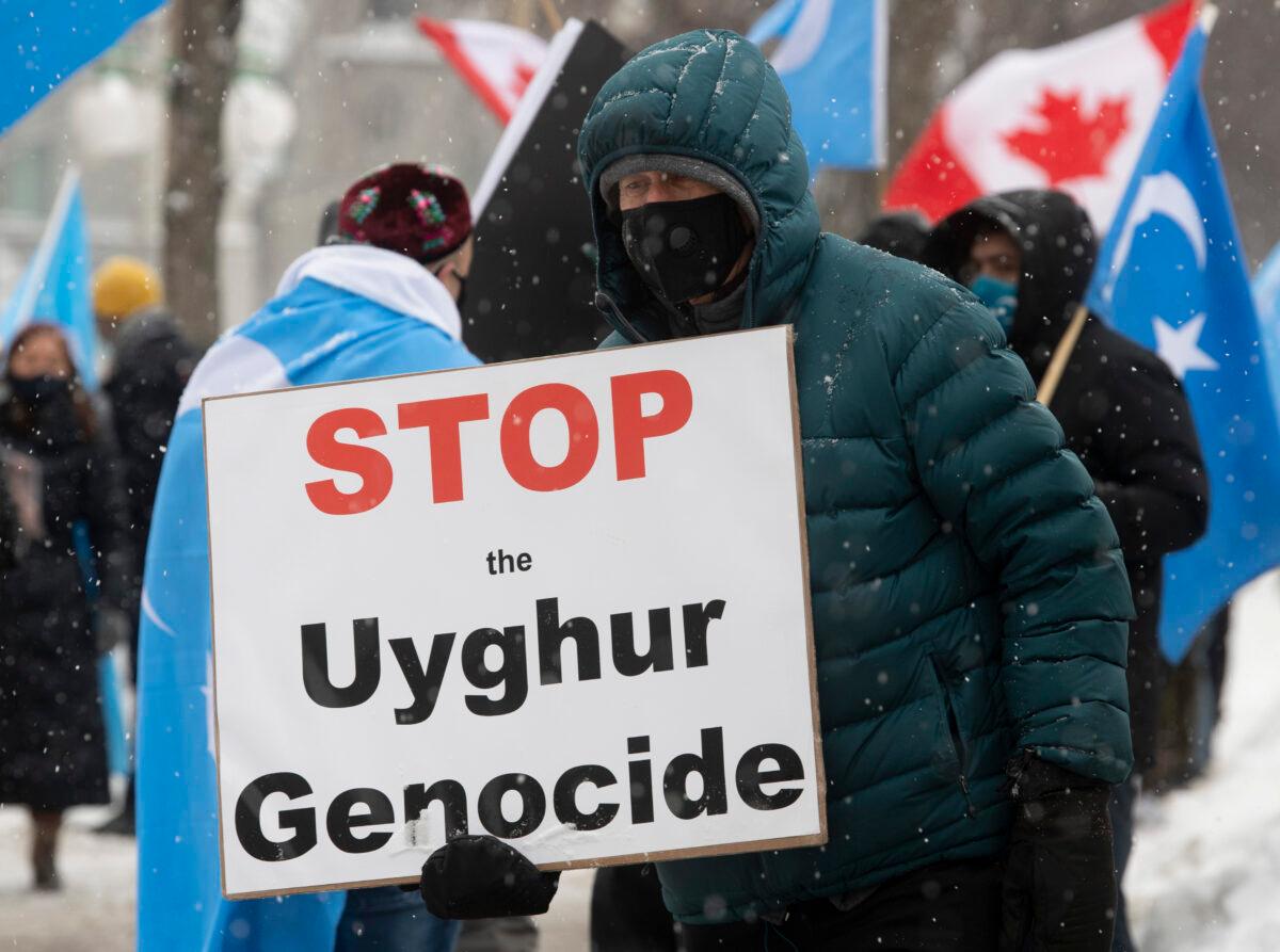 Protesters gather outside the Parliament buildings in Ottawa, Canada, on Feb. 22, 2021. (Adrian Wyld/Canadian Press)