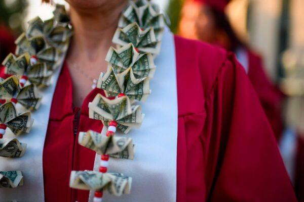 A graduating student wears a money lei, a necklace made of US dollar bills, at the Pasadena City College graduation ceremony, in Pasadena, Calif., on June 14, 2019. (Robyn Beck/AFP via Getty Images)