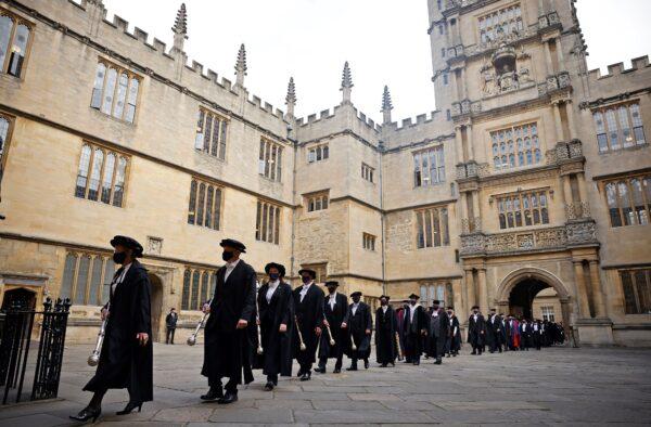 Honorands and senior university members take part in the annual Encaenia ceremony at Oxford University in Oxford, west of London, on Sept. 22, 2021. (Tolga Akmen/AFP via Getty Images)