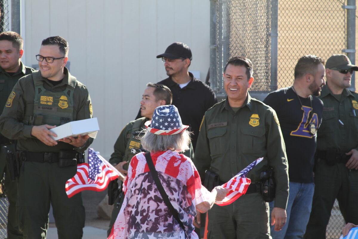 A demonstrator greets border agents at a Border Patrol facility in Indio, Calif., on Nov. 11, 2021. (Brad Jones/The Epoch Times)