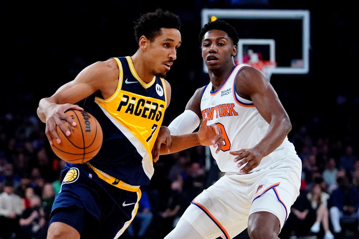 Indiana Pacers' Malcolm Brogdon (7) drives past New York Knicks' RJ Barrett (9) during the first half of an NBA basketball game in New York, on Nov. 15, 2021. (Frank Franklin II/AP Photo)