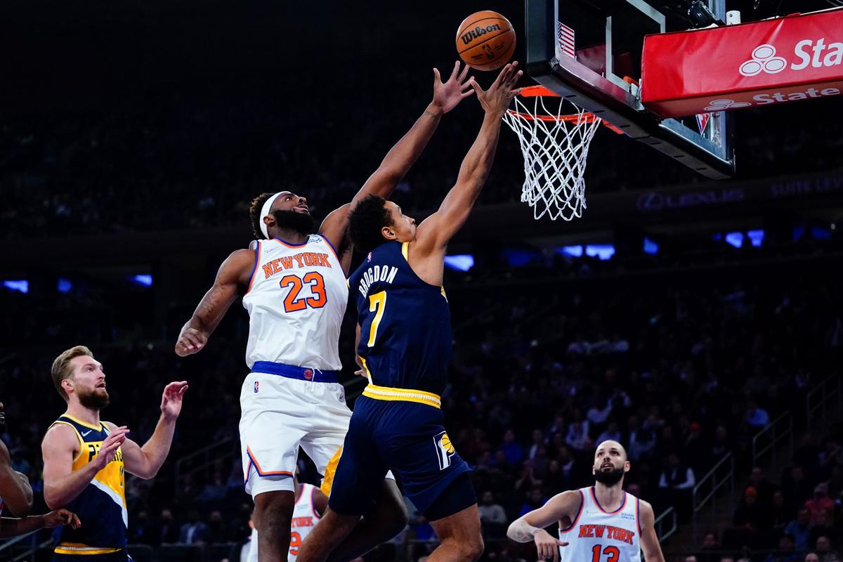 New York Knicks' Mitchell Robinson (23) blocks a shot by Indiana Pacers' Malcolm Brogdon (7) during the first half of an NBA basketball game in New York, on Nov. 15, 2021. (Frank Franklin II/AP Photo)